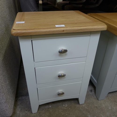 1595 - A cream and oak three drawer bedside chest   *This lot is subject to VAT