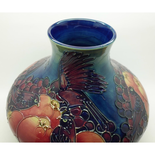 610 - A Moorcroft Finches and fruit vase and stand, 19.5cm