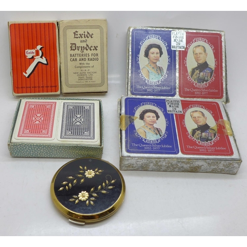 667 - Five packs of playing cards and a compact