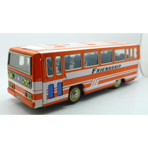 671 - A 1970's Chinese MF-235 friction driven tin plate coach, 30cm