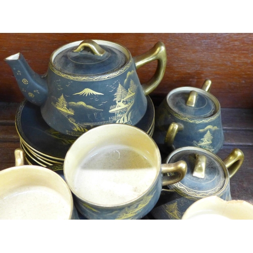 691 - A Japanese tea set with teapot, cream and sugar, one cup a/f