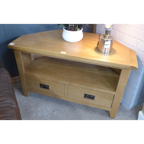 1667 - A rustic oak corner TV unit (NC-CTV-OAK) * this lot is subject to VAT