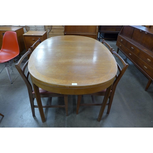 150 - A Nathan teak dining table and four chairs