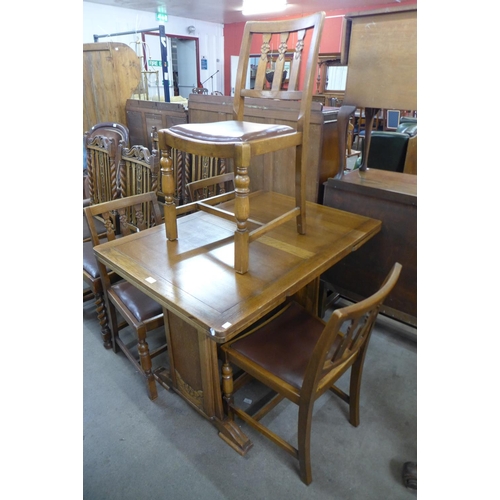 186 - An oak draw-leaf table and four chairs