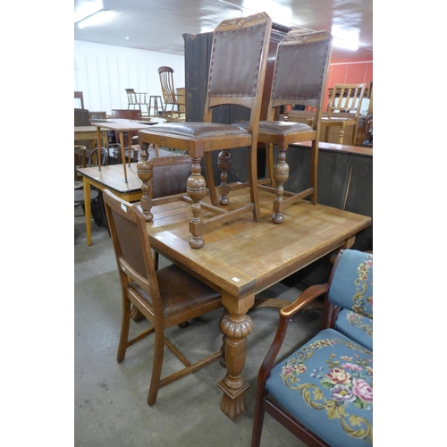 236 - An oak draw-leaf dining table and four chairs