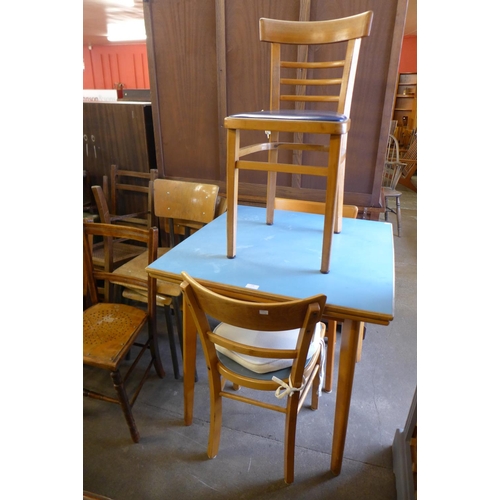 256 - A Formica kitchen table and three chairs