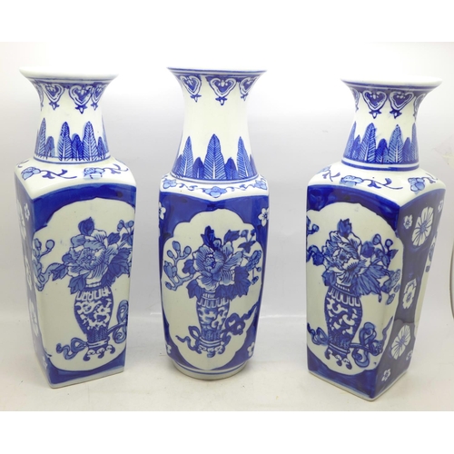 615 - A pair of blue and white Chinese vases, 26.5cm and one other