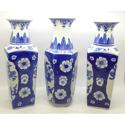 615 - A pair of blue and white Chinese vases, 26.5cm and one other