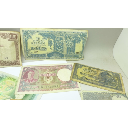 648 - A collection of sixpences and foreign banknotes