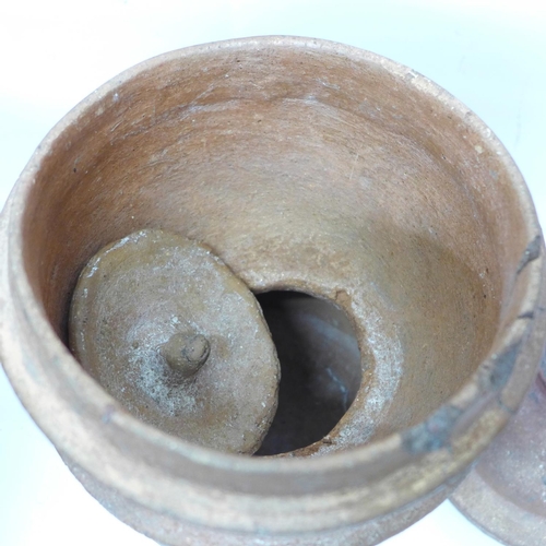 795 - A large mortar and a lidded unglazed jar, possibly for steaming rice