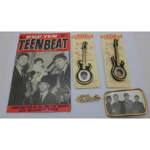 819 - The Beatles collection, a buckle, two guitar brooches, a name brooch and a Teen Beat No.1