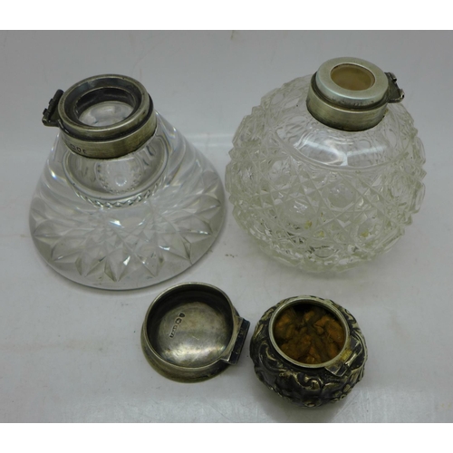 840 - A Victorian silver topped ship's inkwell and a silver topped scent bottle, top dented, both hinges r... 