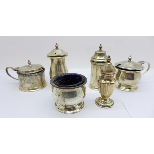 868 - Silver condiments;- a three piece set, a mustard and pepper by Mappin & Webb and a pepperette, 235g