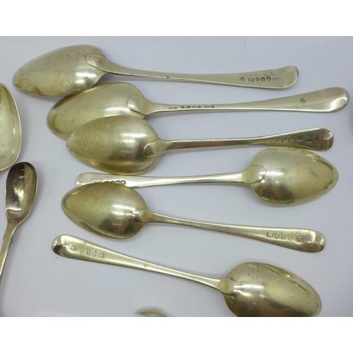 876 - A collection of silver spoons and two pairs of silver sugar bows, mainly 19th Century, 415g