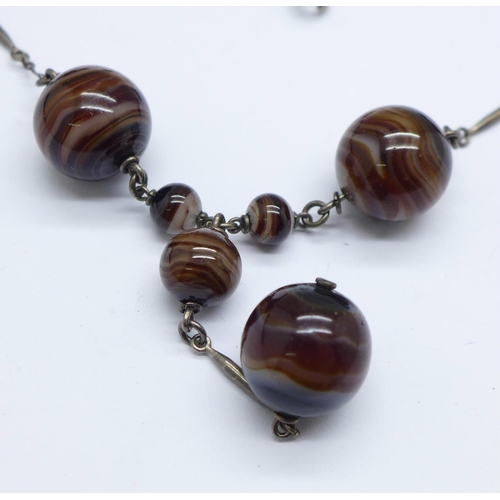 975 - A long banded agate necklace