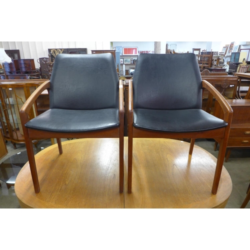 119 - A pair of Danish Henning Kjaernulf for Korup Stolefabrik model 23 teak and black vinyl chairs