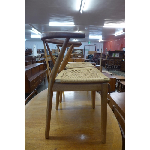 120 - A pair of Danish Henning Kjaernulf for Bruno Hansen model 225 teak and cord seated chairs