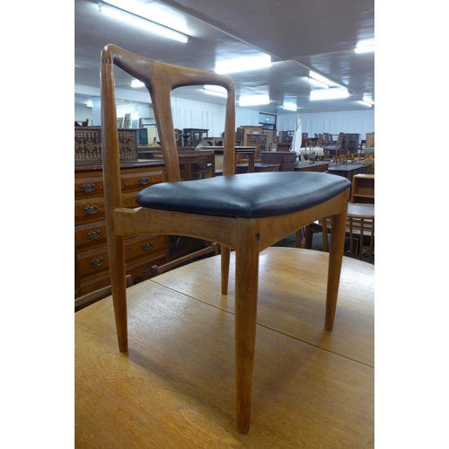 128 - A set of six Danish Johannes Andersen for Uldum Mobelfabfabrik Juliane oak and black vinyl chairs