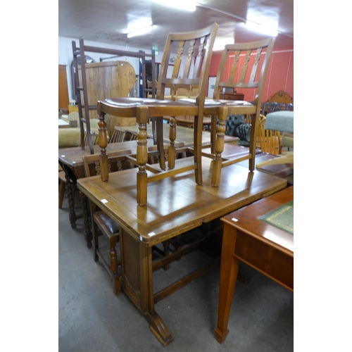 186 - An oak draw-leaf table and four chairs