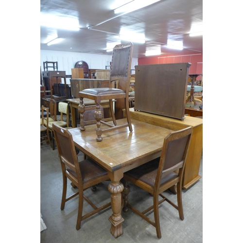 236 - An oak draw-leaf dining table and four chairs