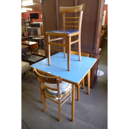 256 - A Formica kitchen table and three chairs