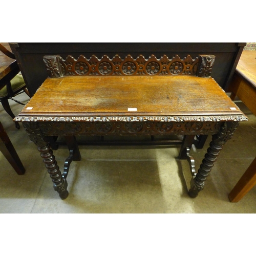 27 - A Victorian Jacobean Revival carved oak hall table