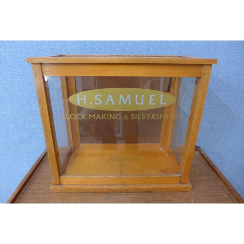 369 - An oak counter top shop shop cabinet, bearing H. Samuel inscription to glass