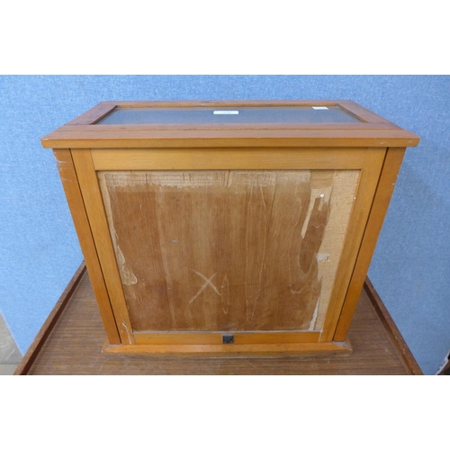 369 - An oak counter top shop shop cabinet, bearing H. Samuel inscription to glass