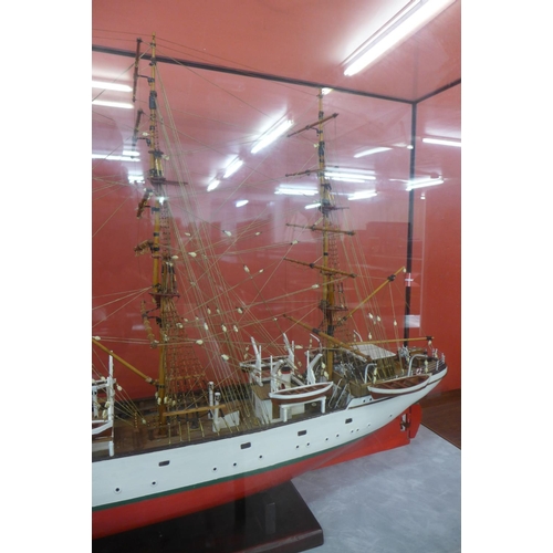 49 - A Danmark model three mast ship, cased, 65cms h, 113cms w, 36cms d