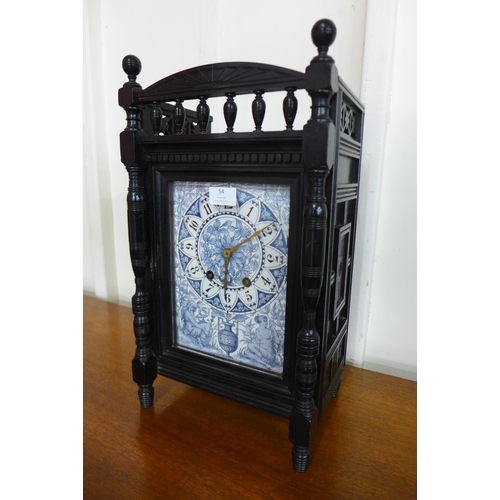 54 - A Victorian Aesthetic Movement ebonised bracket clock, with blue and white porcelain dial, 48cms h