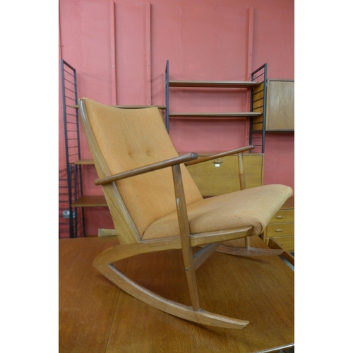 78 - A Danish Kubus Boomerang teak and orange fabric rocking chair, model no. 97, designed by Georg Jense... 