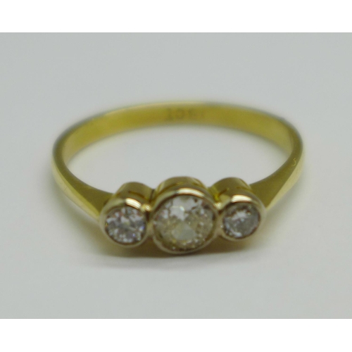 1018 - An 18ct gold and three stone diamond ring, 3g, S