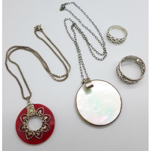 1032 - Two silver rings and two silver mounted pendants and chains