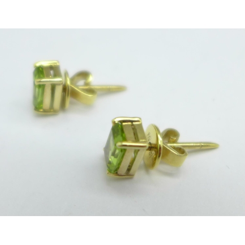 1052 - A pair of 14ct gold and peridot earrings, 3g