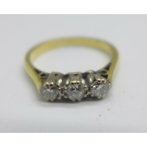 1062 - A yellow metal, three stone diamond ring, 2.6g, L