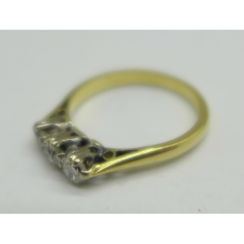 1062 - A yellow metal, three stone diamond ring, 2.6g, L