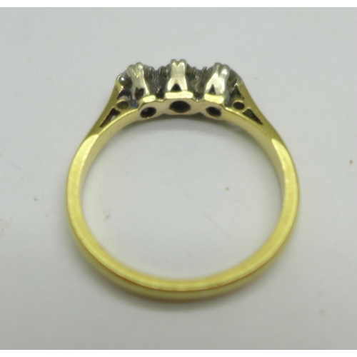 1062 - A yellow metal, three stone diamond ring, 2.6g, L