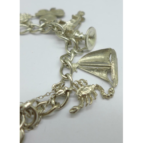 1067 - A silver charm bracelet, 42g