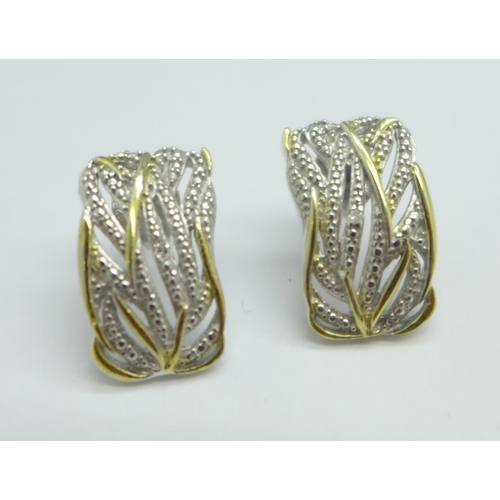 1095 - A pair of silver gilt earrings with diamond accents