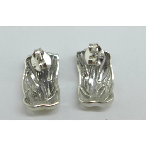 1095 - A pair of silver gilt earrings with diamond accents