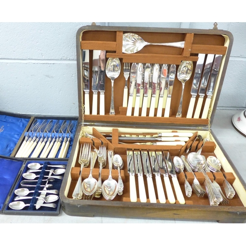 1132 - A canteen of cutlery, a set of six plated knives and forks, a cased set of six plated spoons with a ... 