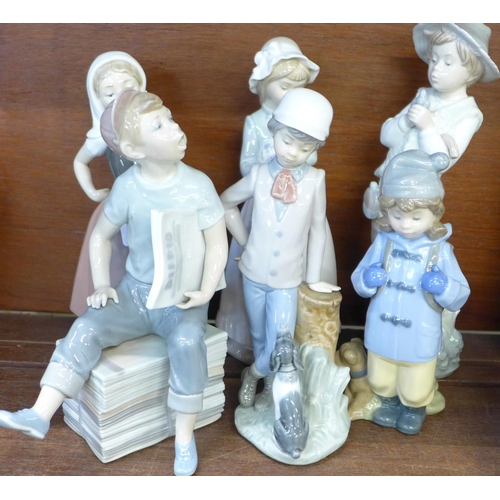 672 - A collection of eleven Nao by Lladro figures, boy sitting a/f