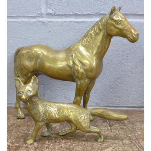 774 - A solid brass model of a horse and fox, 8.84kg gross weight