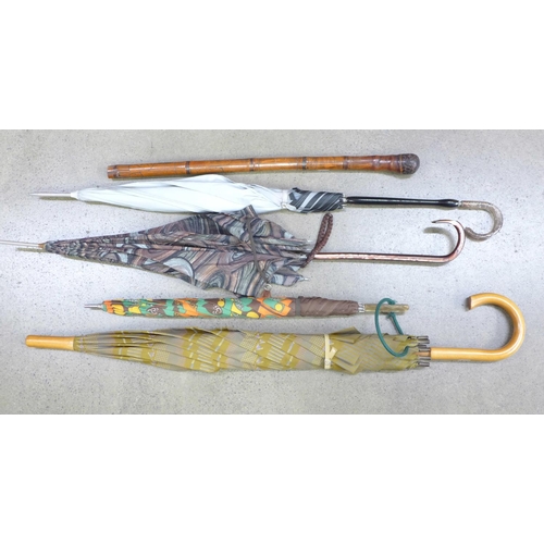 783 - Four vintage umbrellas, three with plastic handles and a bamboo cane with oriental carving