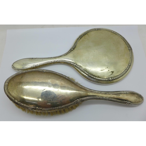 795 - A silver backed mirror and brush