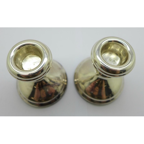 829 - A pair of small silver candlesticks