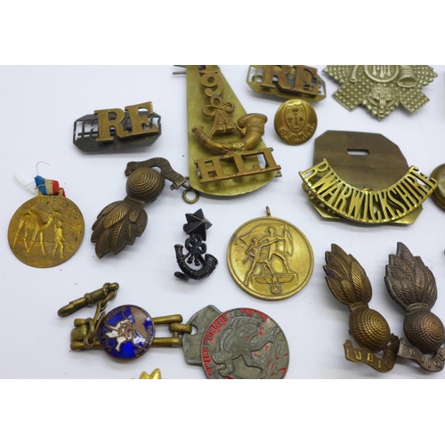 838 - A collection of military badges, buttons, etc.