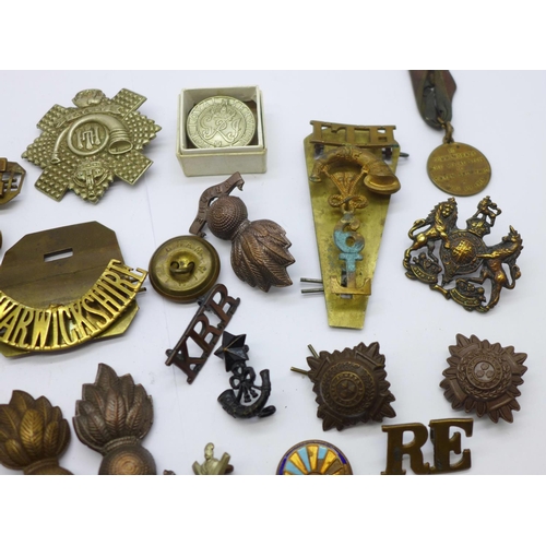 838 - A collection of military badges, buttons, etc.