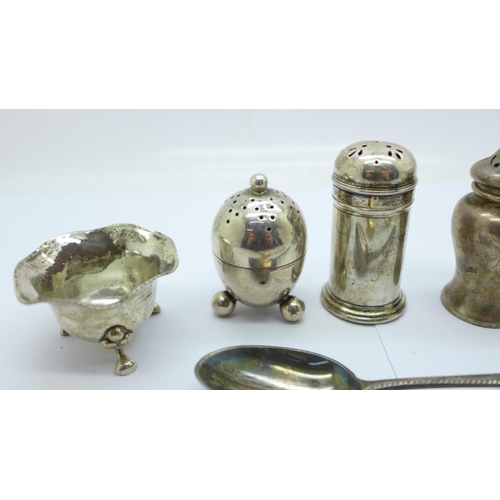 853 - A Georgian silver egg cup, two silver spoons, (one 800 silver), and six silver condiments, 134g