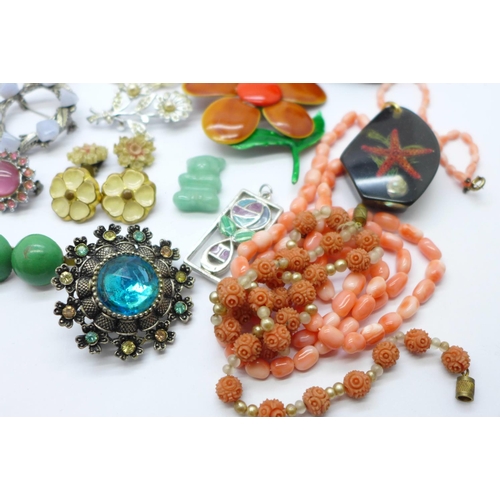 855 - A carved coral bead and pearl necklace, a coral necklace, lucite pendant, brooches, etc.